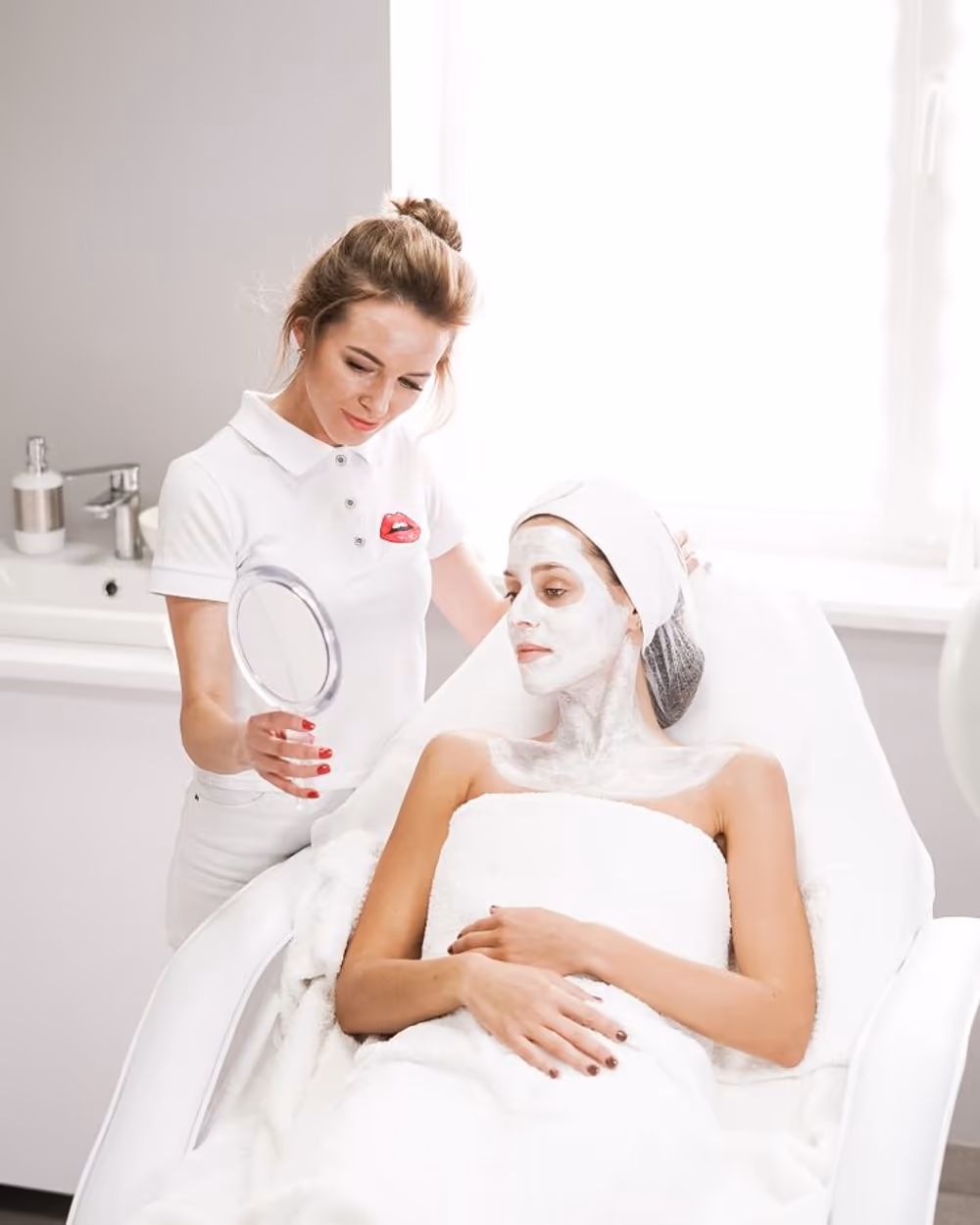 A practitioner reviewing results with a serene client at a follow-up, mirror in hand